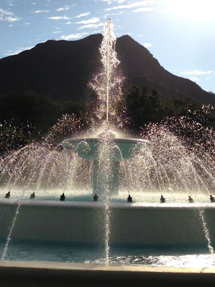 a smaller portion of the Dillingham Fountain with Diamond Head in the background