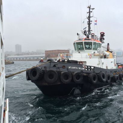 A tugboat puling our ship around so it can leave the harbor in Halifax